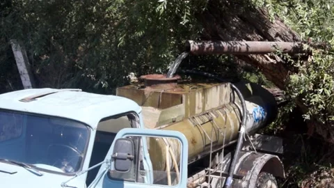 A set of clean drinking water in a tanker truck from a homemade waterfall. Stock Footage 167518137