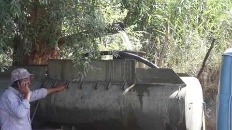 A set of clean drinking water in a tanker truck from a homemade waterfall. Stock Footage 167518459
