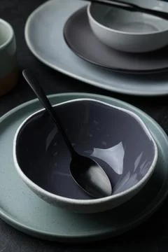 Set of clean tableware on black table Stock Photos