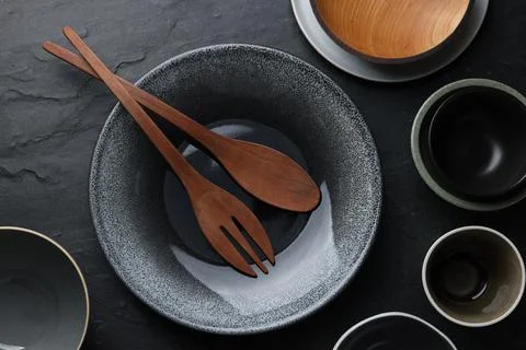 Set of clean tableware on black table, flat lay Stock Photos