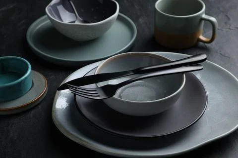 Set of clean tableware on black table Stock Photos
