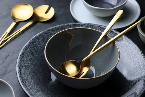 Set of clean tableware on black table, closeup Stock Photos