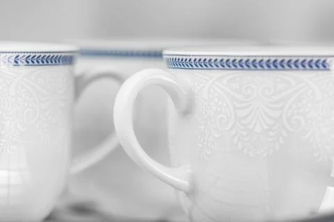 Set of clean white cups located on the shelf Stock Photos