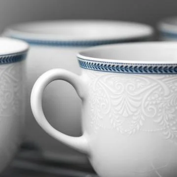 Set of clean white cups located on the shelf Stock Photos