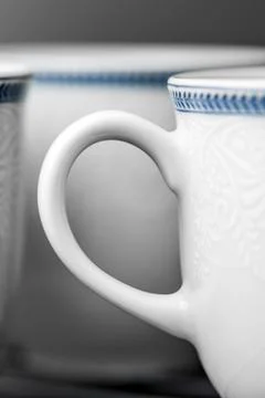 Set of clean white cups located on the shelf Stock Photos