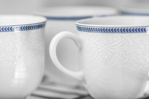 Set of clean white cups located on the shelf Stock Photos