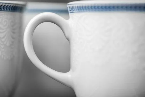 Set of clean white cups located on the shelf Stock Photos