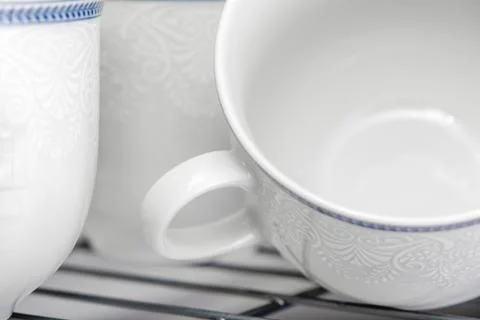 Set of clean white cups located on the shelf Stock Photos