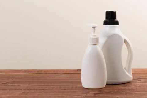 Set of cleaning products on the table on a colored background. Stock Photos