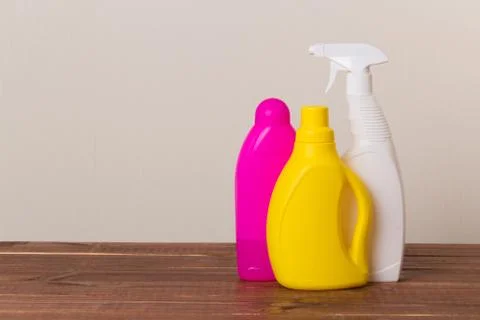 Set of cleaning products on the table on a colored background. Stock Photos
