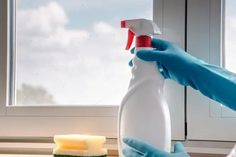 A set for cleaning windows. Hand in a blue glove. Cleaning tools and equipmen Stock Photos