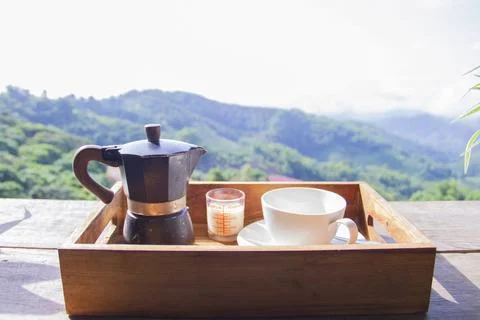 Set of coffee maker,  moka pot on woodle box with mountain and village as bac Stock Photos