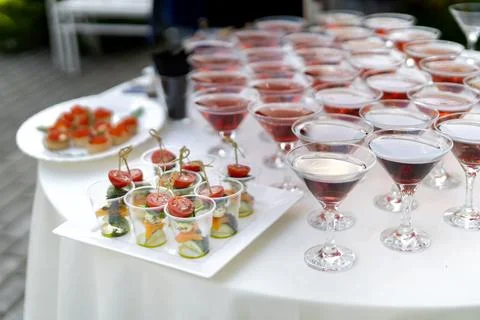 Set of cold snacks, with canapes in the foreground. In the background drinks  스톡 사진