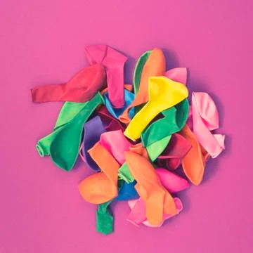 Set of colored balloons on pink background Flat lay top view Stock Photos