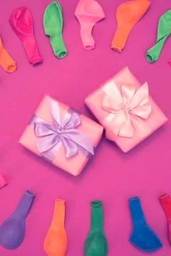 Set of colored balloons on pink background Flat lay top view Stock Photos