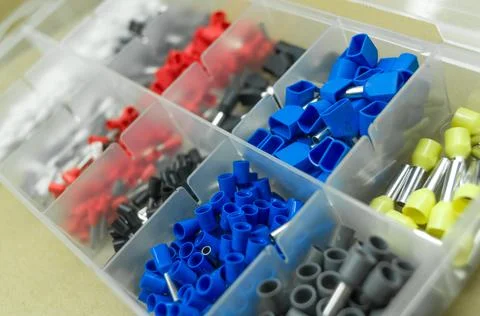 A set of colored crimp terminals for electrical wires. Crimping sleeves of Stock Photos