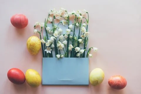 Set of colored eggs and flowers in the envelope Stock Photos
