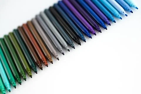 A set of colored felt-tip pens in a dark palette. Drawing tools on a white ba Stock Photos
