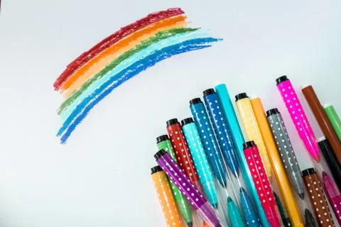 A set of colored markers with a rainbow drawn on paper. the view from the top. a Stock Photos