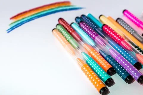 A set of colored markers with a rainbow drawn on paper. the view from the top. a Stock Photos