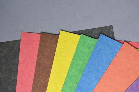 Set of colored paper on a gray background. Stock Photos