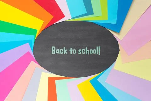 Set of colored paper for schoolwork on background of school board. Flat lay,  Stock Photos