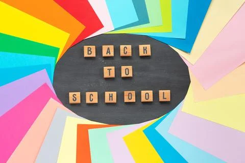 Set of colored paper for schoolwork on background of school board. Flat lay.. Stock Photos