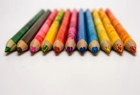 Set of colored pencils lying on the notebook. White background. Isolate. Chri Stock Photos