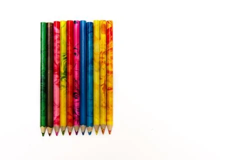 Set of colored pencils lying on the notebook. White background. Isolate. Chri Stock Photos