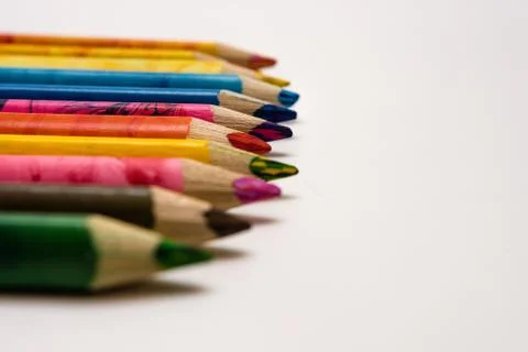 Set of colored pencils lying on the notebook. White background. Isolate. Chri Stock Photos