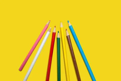 Set of colored pencils on a yellow background Stock Photos