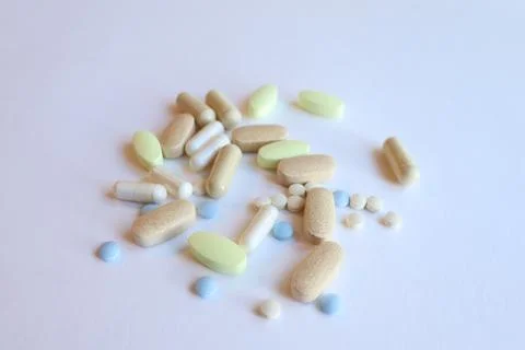 A set of colored pills on a white background and pharmacy. Stock Photos