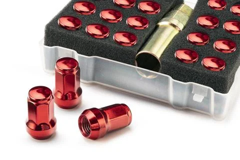 A set of colored red wheel nuts for wheels. auto tuning and car maintenance Stock Photos
