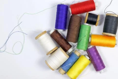 A set of colored sewing threads on spools, top view. Stock Photos