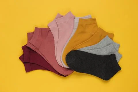 Set of colored socks on yellow background. Top view Stockfoto's