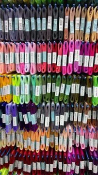 Set of colored threads for sewing on coils. Pile of big colorful spools of Stock Photos