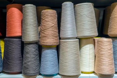Set of colored threads for sewing on coils. Pile of big colorful spools of th Stock Photos