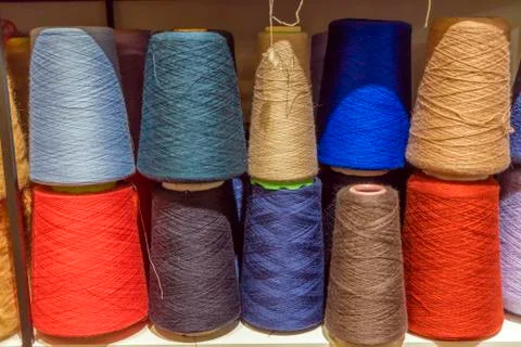 Set of colored threads for sewing on coils. Pile of big colorful spools of th Stock Photos