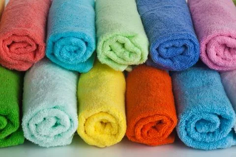 Set of colored towels on white. Stock Photos