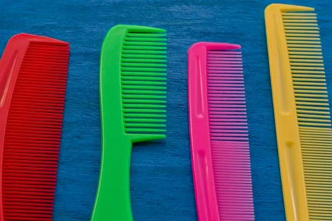 A set of colorful children's combs on a blue background. Bright hair care kit Stock Photos
