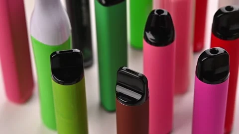 Set of colorful disposable electronic cigarettes of different shapes on a white Stock Footage 264903574