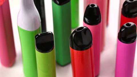 Set of colorful disposable electronic cigarettes of different shapes on a white 스톡 동영상 264903590