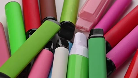 Set of colorful disposable electronic cigarettes of different shapes on a white Stock Footage 264903597