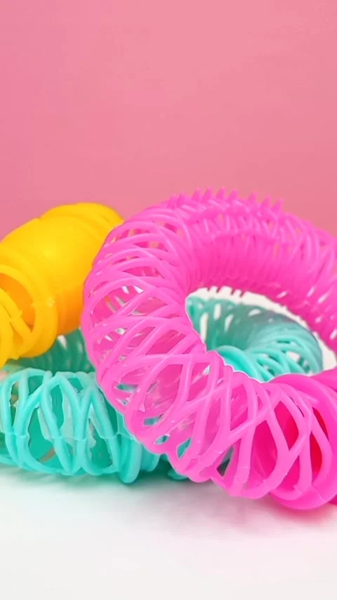 Set of Colorful Donut Hair Rollers Rotating on Pink Background, Heatless Curlers Stock Footage 344802553