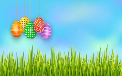 Set of colorful Easter eggs hanging on sky background with green grass. Banner. Stock Illustration
