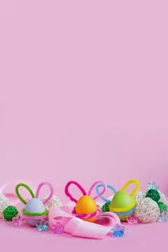 Set of colorful eggs with Easter bunny ears lie near the ribbon and ornaments Stock Photos