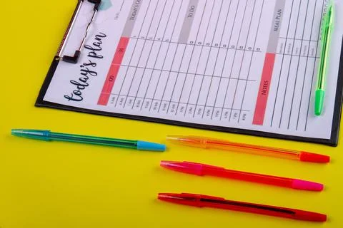 Set colorful pens and week calendar close-up. Stock Photos