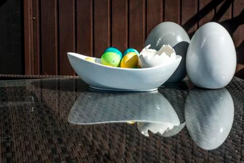 Set colorful shiny Easter eggs and grey and white colored ceramic and reflect Stock Photos