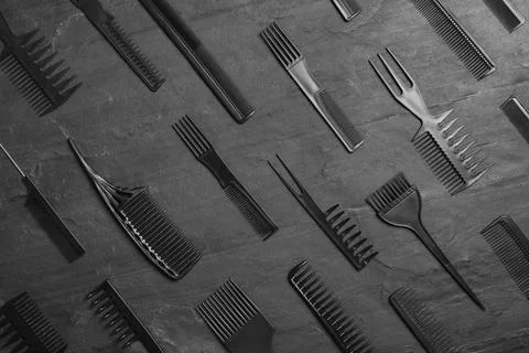 Set of combs on black slate background, flat lay Stock Photos