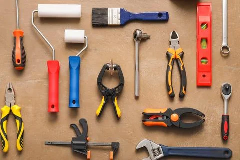 Set of construction tools on beige grunge background Stock Photos